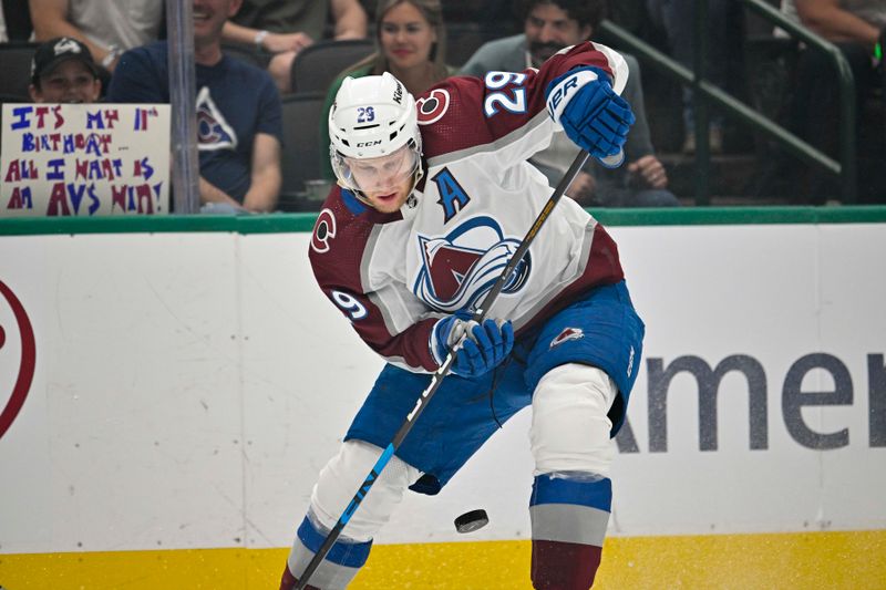 May 7, 2024; Dallas, Texas, USA; Colorado Avalanche center Nathan MacKinnon (29) attempts to control the puck in the Dallas Stars zone during the third period in game one of the second round of the 2024 Stanley Cup Playoffs at American Airlines Center. Mandatory Credit: Jerome Miron-USA TODAY Sports