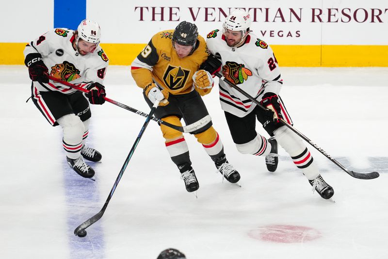 Apr 16, 2024; Las Vegas, Nevada, USA; Vegas Golden Knights center Ivan Barbashev (49) controls the puck between Chicago Blackhawks left wing Landon Slaggert (84) and defenseman Jaycob Megna (24) during the third period at T-Mobile Arena. Mandatory Credit: Stephen R. Sylvanie-USA TODAY Sports