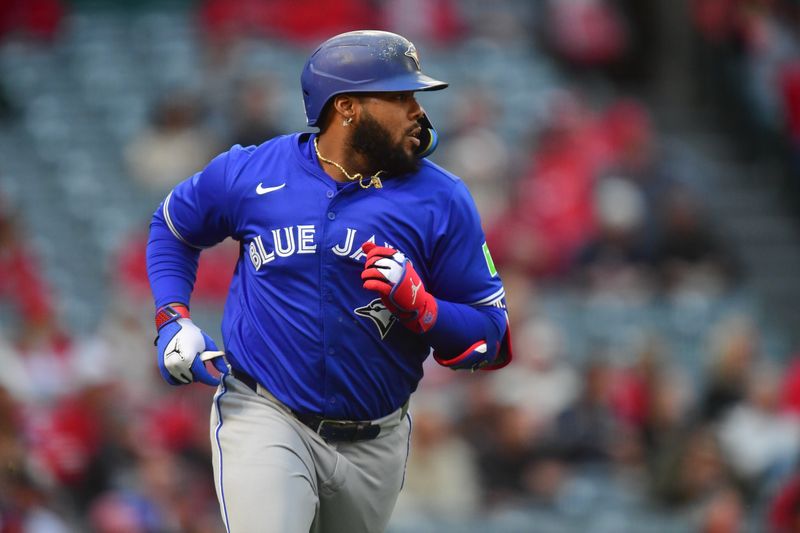 May 6, 2025; Anaheim, California, USA; Toronto Blue Jays first baseman Vladimir Guerrero Jr. (27) hits a single against the Los Angeles Angels during the first inning at Angel Stadium. Mandatory Credit: Gary A. Vasquez-Imagn Images
