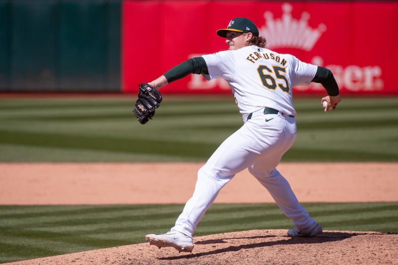 May 7, 2024; Oakland, California, USA; Oakland Athletics relief pitcher Tyler Ferguson (65) throws a pitch during the ninth inning against the Texas Rangers at Oakland-Alameda County Coliseum. Mandatory Credit: Ed Szczepanski-USA TODAY Sports