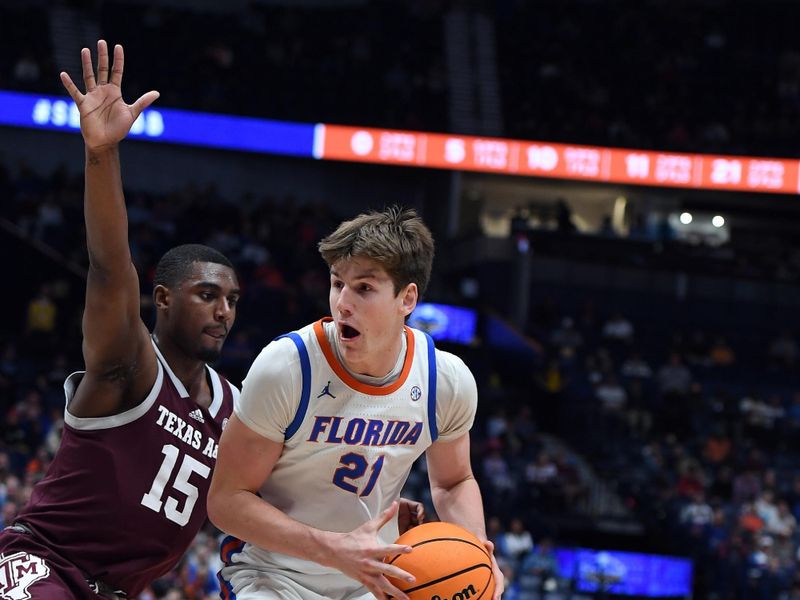 Mar 16, 2024; Nashville, TN, USA; Florida Gators forward Alex Condon (21) drives to the basket against Texas A&M Aggies forward Henry Coleman III (15) during the first half at Bridgestone Arena. Mandatory Credit: Christopher Hanewinckel-USA TODAY Sports