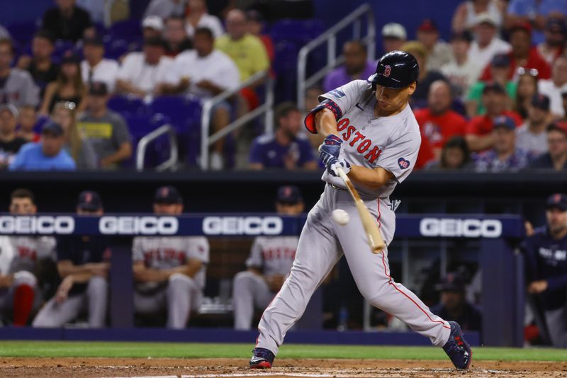 Jul 3, 2024; Miami, Florida, USA; Boston Red Sox left fielder Masataka Yoshida (7) hits a single against the Miami Marlins during the second inning at loanDepot Park. Mandatory Credit: Sam Navarro-USA TODAY Sports