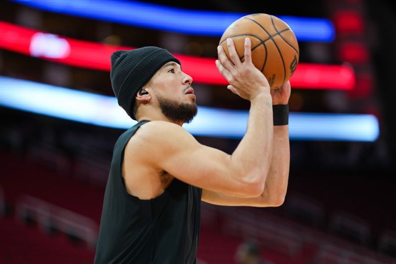 HOUSTON, TEXAS - DECEMBER 27: Devin Booker #1 of the Phoenix Suns shoots the ball during warmups prior to the game against the Houston Rockets at Toyota Center on December 27, 2023 in Houston, Texas. User expressly acknowledges and agrees that, by downloading and or using this photograph, User is consenting to the terms and conditions of the Getty Images License Agreement. (Photo by Alex Bierens de Haan/Getty Images)