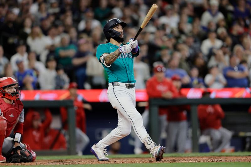 Jun 1, 2024; Seattle, Washington, USA;  Seattle Mariners shortstop J.P. Crawford (3) watches the flight of the ball on a grand slam against the Los Angeles Angels during the fourth inning at T-Mobile Park. Mandatory Credit: John Froschauer-USA TODAY Sports
