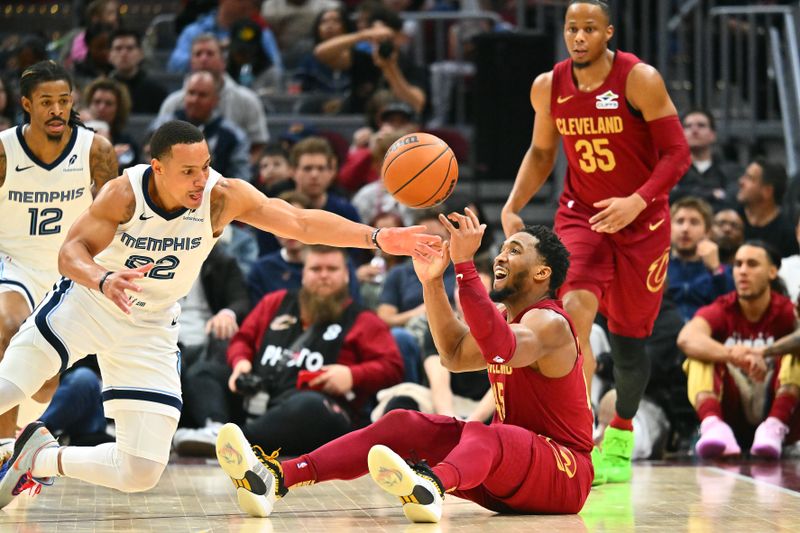 CLEVELAND, OHIO - FEBRUARY 23: Desmond Bane #22 of the Memphis Grizzlies and Donovan Mitchell #45 of the Cleveland Cavaliers go to the floor for a loose ball during the third quarter at Rocket Arena on February 23, 2025 in Cleveland, Ohio. The Cavaliers defeated the Grizzlies 129-123. NOTE TO USER: User expressly acknowledges and agrees that, by downloading and or using this photograph, User is consenting to the terms and conditions of the Getty Images License Agreement. (Photo by Jason Miller/Getty Images)