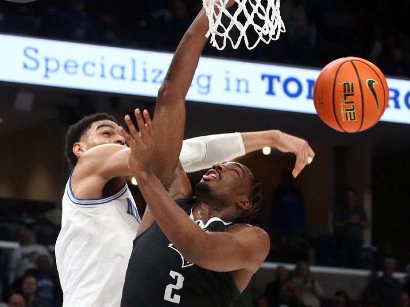 Jan 31, 2024; Memphis, Tennessee, USA; Memphis Tigers forward Nicholas Jourdain (2) blocks the shot of Rice Owls guard Mekhi Mason (2) during the second half at FedExForum. Mandatory Credit: Petre Thomas-USA TODAY Sports