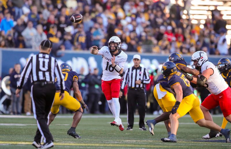 Nov 18, 2023; Morgantown, West Virginia, USA; Cincinnati Bearcats quarterback Brady Lichtenberg (16) throws a pass against the West Virginia Mountaineers during the second quarter at Mountaineer Field at Milan Puskar Stadium. Mandatory Credit: Ben Queen-USA TODAY Sports