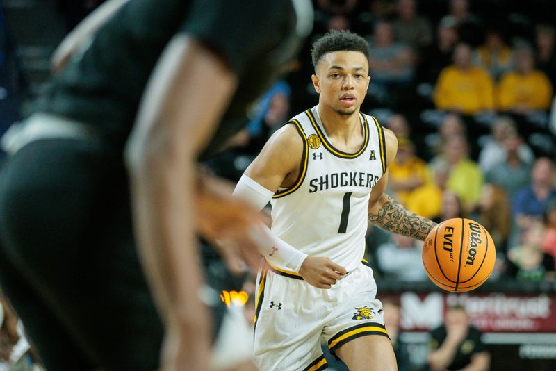 Mar 2, 2024; Wichita, Kansas, USA; Wichita State Shockers guard Xavier Bell (1) brings the ball up court during the first half against the Rice Owls at Charles Koch Arena. Mandatory Credit: William Purnell-USA TODAY Sports