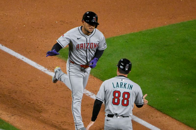 May 23, 2025; St. Louis, Missouri, USA;  Arizona Diamondbacks pinch hitter Gabriel Moreno (14) is congratulated by third base coach Shaun Larkin (88) after hitting a two run home run against the St. Louis Cardinals during the ninth inning at Busch Stadium. Mandatory Credit: Jeff Curry-Imagn Images