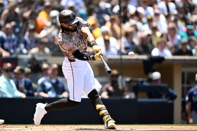 May 18, 2025; San Diego, California, USA; San Diego Padres right fielder Fernando Tatis Jr. (23) hits a solo home run during the first inning against the Seattle Mariners at Petco Park. Mandatory Credit: Denis Poroy-Imagn Images
