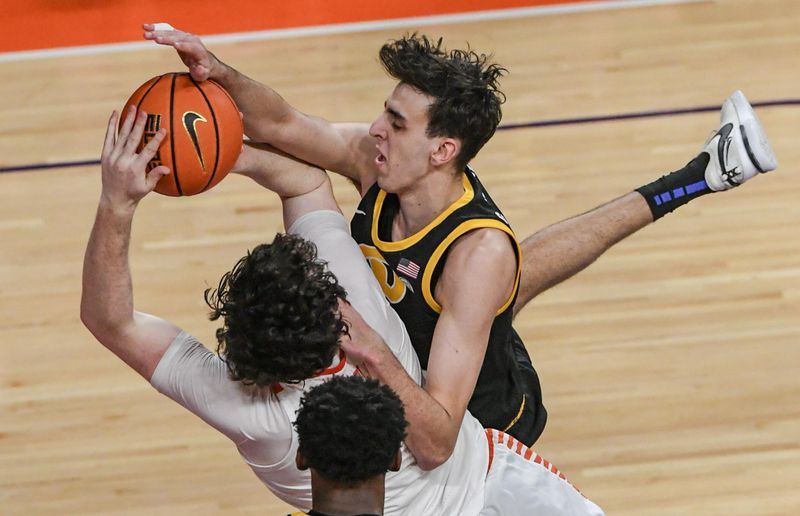 Feb 27, 2024; Clemson, South Carolina, USA;  Clemson junior forward Ian Schieffelin (4) is fouled by Pitt forward Guillermo Diaz Graham (25) during the first half at Littlejohn Coliseum. Mandatory Credit: Ken Ruinard-USA TODAY Sports