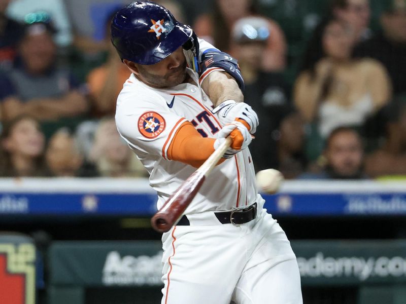 May 27, 2025; Houston, Texas, USA; Houston Astros designated hitter Jose Altuve (27) hits a single against the Athletics in the first inning  at Daikin Park. Mandatory Credit: Thomas Shea-Imagn Images