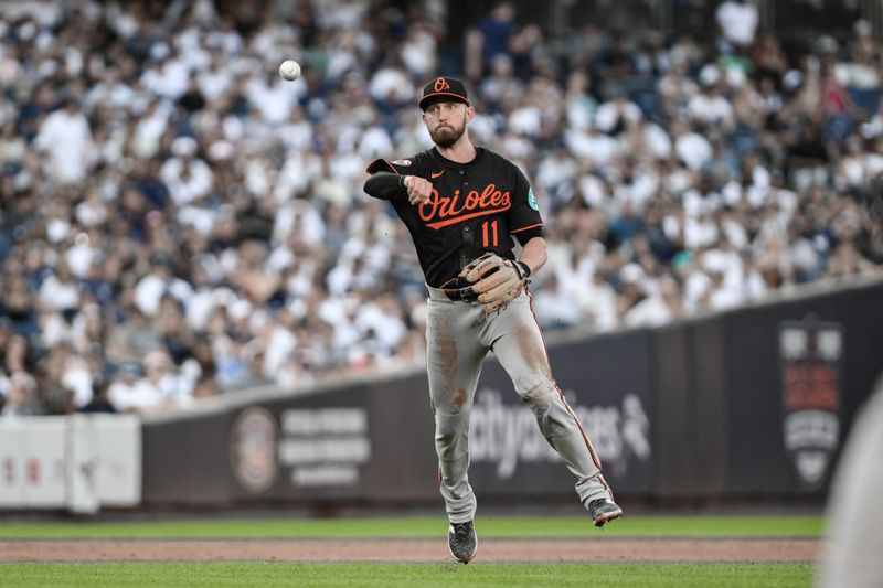 Sep 28, 2025; Bronx, New York, USA; Baltimore Orioles third baseman Jordan Westburg (11) throws out New York Yankees outfielder Cody Bellinger (not pictured) after fielding a ground ball during the eighth inning at Yankee Stadium. Mandatory Credit: John Jones-Imagn Images