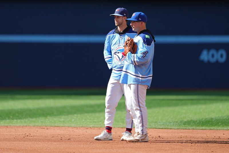 Aug 7, 2024; Toronto, Ontario, CAN; Toronto Blue Jays third baseman Ernie Clement (28) talks with outfielder Davis Schneider (36) during batting practice before a game against the Baltimore Orioles at Rogers Centre. Mandatory Credit: Nick Turchiaro-USA TODAY Sports