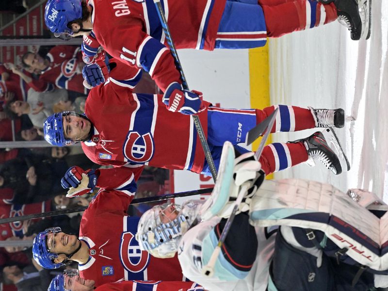 Dec 4, 2023; Montreal, Quebec, CAN; Montreal Canadiens forward Tanner Pearson (70) celebrates with teammates including forward Brendan Gallagher (11) and defenseman Jayden Struble (47) and defenseman Johnathan Kovacevic (26) after scoring a goal against Seattle Kraken goalie Philipp Grubauer (31) during the second period at the Bell Centre. Mandatory Credit: Eric Bolte-USA TODAY Sports