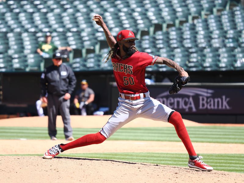 May 17, 2023; Oakland, California, USA; Arizona Diamondbacks relief pitcher Miguel Castro (50) pitches the ball against the Oakland Athletics during the ninth inning at Oakland-Alameda County Coliseum. Mandatory Credit: Kelley L Cox-USA TODAY Sports