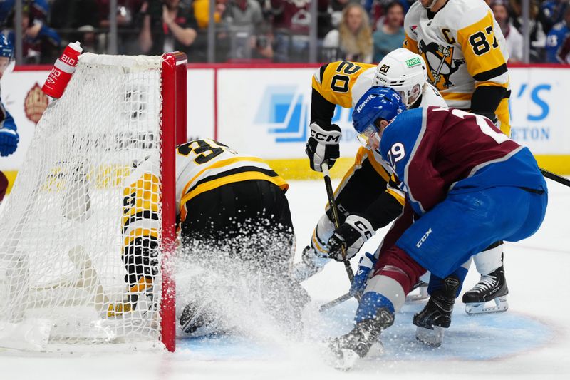 Mar 24, 2024; Denver, Colorado, USA; Pittsburgh Penguins goaltender Alex Nedeljkovic (39) makes a save on Colorado Avalanche center Nathan MacKinnon (29) in the second period at Ball Arena. Mandatory Credit: Ron Chenoy-USA TODAY Sports