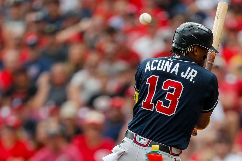 Jun 24, 2023; Cincinnati, Ohio, USA; Atlanta Braves right fielder Ronald Acuna Jr. (13) gets hit by a pitch thrown by Cincinnati Reds starting pitcher Graham Ashcraft (not pictured) during the first inning at Great American Ball Park. Mandatory Credit: Katie Stratman-USA TODAY Sports