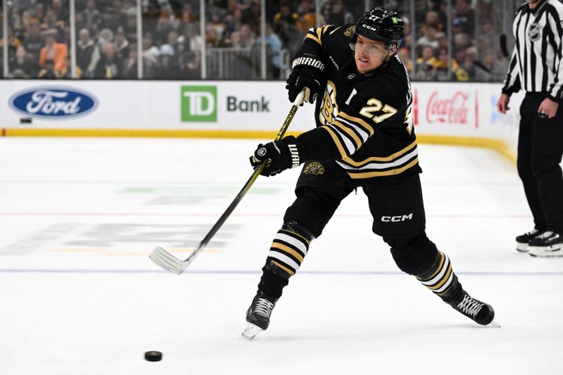 Nov 9, 2023; Boston, Massachusetts, USA; Boston Bruins defenseman Hampus Lindholm (27) attempts a shot against the New York Islanders during the first period at the TD Garden. Mandatory Credit: Brian Fluharty-USA TODAY Sports