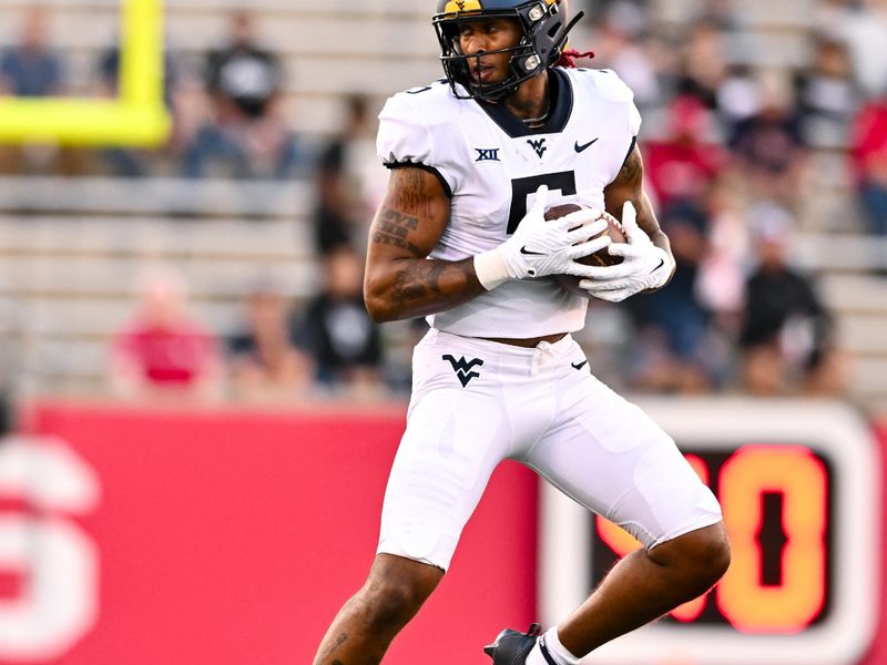 Oct 12, 2023; Houston, Texas, USA; West Virginia Mountaineers wide receiver Devin Carter (5) receives a pass during the first quarter against the Houston Cougars  at TDECU Stadium. Mandatory Credit: Maria Lysaker-USA TODAY Sports