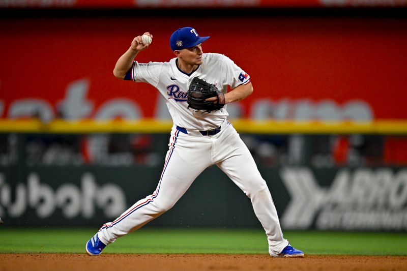 Apr 27, 2024; Arlington, Texas, USA; Texas Rangers shortstop Corey Seager (5) throws to first base during the sixth inning against the Cincinnati Reds at Globe Life Field. Mandatory Credit: Jerome Miron-USA TODAY Sports