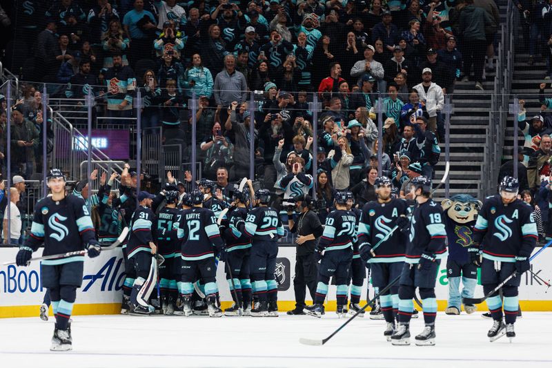 Oct 19, 2024; Seattle, Washington, USA; The Seattle Kraken celebrate an overtime goal against the Calgary Flames after the game at Climate Pledge Arena. Mandatory Credit: Caean Couto-Imagn Images