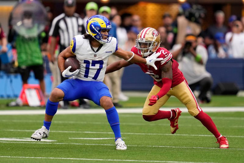 Los Angeles Rams wide receiver Puka Nacua, left, tries to fend off San Francisco 49ers cornerback Deommodore Lenoir during the second half of an NFL football game Sunday, Sept. 17, 2023, in Inglewood, Calif. (AP Photo/Ashley Landis)