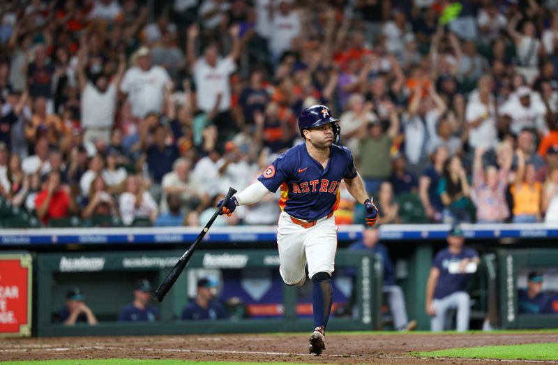 Sep 21, 2025; Houston, Texas, USA; Houston Astros second baseman Jose Altuve (27) hits an RBI single against the Seattle Mariners  in the seventh inning at Daikin Park. Mandatory Credit: Thomas Shea-Imagn Images
