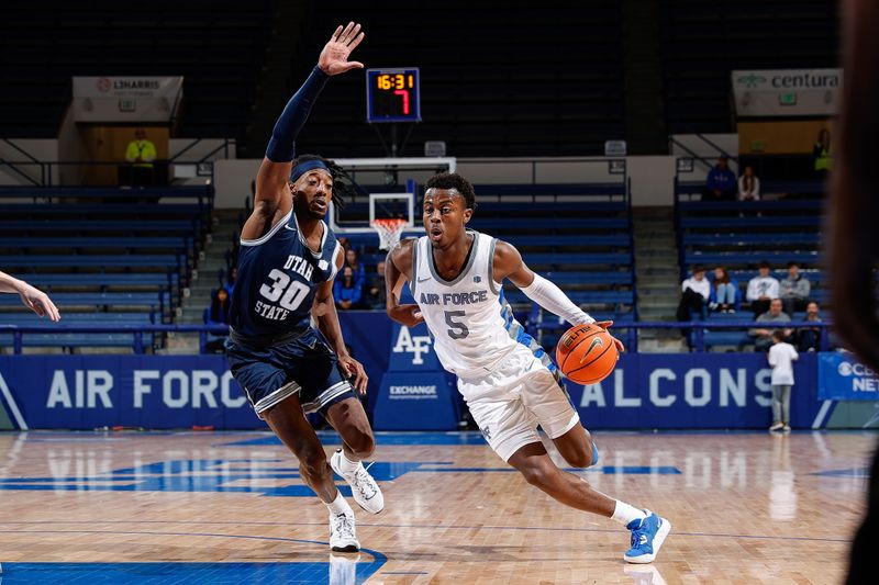 Jan 3, 2023; Colorado Springs, Colorado, USA; Air Force Falcons guard Ethan Taylor (5) drives to the net against Utah State Aggies forward Dan Akin (30) in the second half at Clune Arena. Mandatory Credit: Isaiah J. Downing-USA TODAY Sports