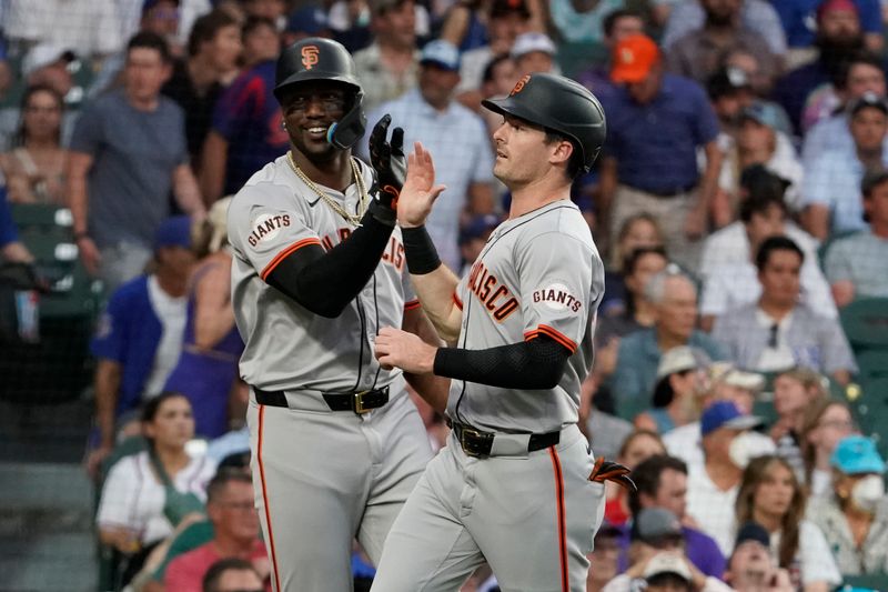 Jun 18, 2024; Chicago, Illinois, USA; San Francisco Giants outfielder Mike Yastrzemski (right) is greeted by designated hitter Jorge Soler (left) after scoring against the Chicago Cubs during the fifth inning at Wrigley Field. Mandatory Credit: David Banks-USA TODAY Sports