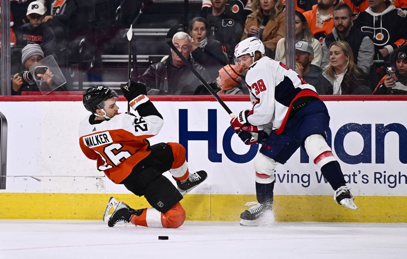 Dec 14, 2023; Philadelphia, Pennsylvania, USA; Philadelphia Flyers defenseman Sean Walker (26) collides with Washington Capitals defenseman Rasmus Sandin (38) in the first period at Wells Fargo Center. Mandatory Credit: Kyle Ross-USA TODAY Sports