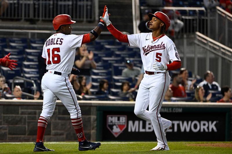 Apr 4, 2023; Washington, District of Columbia, USA; Washington Nationals shortstop CJ Abrams (5) is congratulated by center fielder Victor Robles (16) after both scored against the Tampa Bay Rays during the second inning at Nationals Park. Mandatory Credit: Brad Mills-USA TODAY Sports