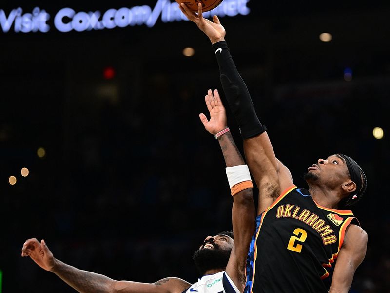 OKLAHOMA CITY, OKLAHOMA - NOVEMBER 17: Shai Gilgeous-Alexander #2 of the Oklahoma City Thunder battles Kyrie Irving #11 of the Dallas Mavericks for a jump ball during the second half at Paycom Center on November 17, 2024 in Oklahoma City, Oklahoma. NOTE TO USER: User expressly acknowledges and agrees that, by downloading and or using this photograph, User is consenting to the terms and conditions of the Getty Images License Agreement. (Photo by Joshua Gateley/Getty Images)