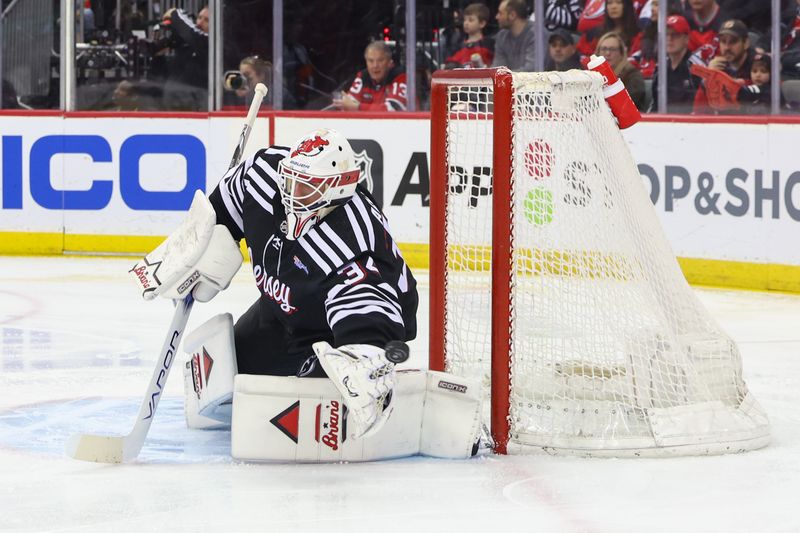 Mar 23, 2024; Newark, New Jersey, USA; New Jersey Devils goaltender Jake Allen (34) makes a save against the Ottawa Senators during the first period at Prudential Center. Mandatory Credit: Ed Mulholland-USA TODAY Sports