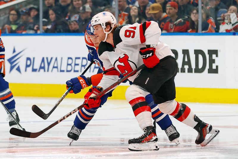 Nov 4, 2024; Edmonton, Alberta, CAN; New Jersey Devils forward Dawson Mercer (91) and Edmonton Oilers forward Vasily Podkolzin (92) battles for position  during the first period at Rogers Place. Mandatory Credit: Perry Nelson-Imagn Images