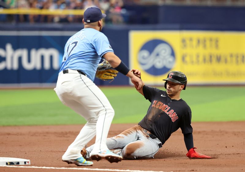 Jul 14, 2024; St. Petersburg, Florida, USA;  Cleveland Guardians outfielder Steven Kwan (38) steals third base as Tampa Bay Rays third base Isaac Paredes (17) attempted to tag him out during the third inning at Tropicana Field. Mandatory Credit: Kim Klement Neitzel-USA TODAY Sports