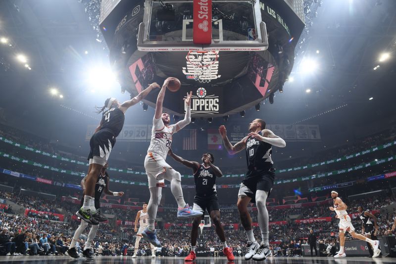 LOS ANGELES, CA - APRIL 10: Jusuf Nurkic #20 of the Phoenix Suns drives to the basket during the game against the LA Clippers on April 10, 2024 at Crypto.Com Arena in Los Angeles, California. NOTE TO USER: User expressly acknowledges and agrees that, by downloading and/or using this Photograph, user is consenting to the terms and conditions of the Getty Images License Agreement. Mandatory Copyright Notice: Copyright 2024 NBAE (Photo by Adam Pantozzi/NBAE via Getty Images)