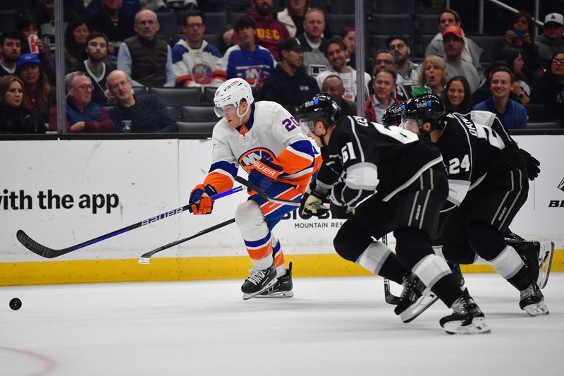 Mar 11, 2024; Los Angeles, California, USA; New York Islanders right wing Hudson Fasching (20) moves the puck ahead of Los Angeles Kings center Trevor Lewis (61) and center Phillip Danault (24) during the third period at Crypto.com Arena. Mandatory Credit: Gary A. Vasquez-USA TODAY Sports