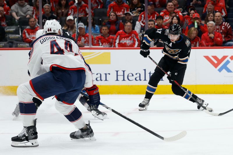 Apr 13, 2025; Washington, District of Columbia, USA; Washington Capitals center Dylan Strome (17) shoots the puck as Columbus Blue Jackets defenseman Erik Gudbranson (44) defends in the first period at Capital One Arena. Mandatory Credit: Geoff Burke-Imagn Images