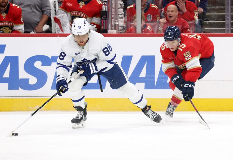 May 11, 2025; Sunrise, Florida, USA; Toronto Maple Leafs right wing William Nylander (88) skates with the puck as Florida Panthers center Anton Lundell (15) defends during the third period in game four of the second round of the 2025 Stanley Cup Playoffs at Amerant Bank Arena. Mandatory Credit: Kim Klement Neitzel-Imagn Images