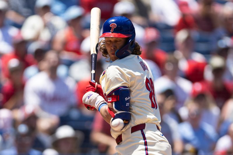 Jun 19, 2024; Philadelphia, Pennsylvania, USA; Philadelphia Phillies third base Alec Bohm (28) is hit by a pitch during the first inning against the San Diego Padres at Citizens Bank Park. Mandatory Credit: Bill Streicher-USA TODAY Sports