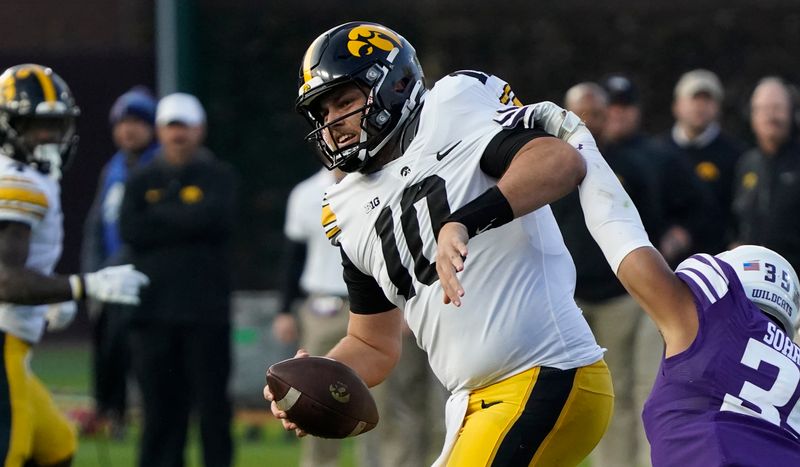 Nov 4, 2023; Chicago, Illinois, USA; Northwestern Wildcats linebacker Kenny Soares Jr. (35) pressures Iowa Hawkeyes quarterback Deacon Hill (10) during the second half at Wrigley Field. Mandatory Credit: David Banks-USA TODAY Sports