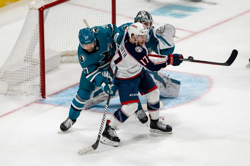 Nov 5, 2024; San Jose, California, USA;  Columbus Blue Jackets right wing Justin Danforth (17) attempts to deflect the puck into the the goal against San Jose Sharks defenseman Timothy Liljegren (37) during the third period the  at SAP Center at San Jose. Mandatory Credit: Neville E. Guard-Imagn Images