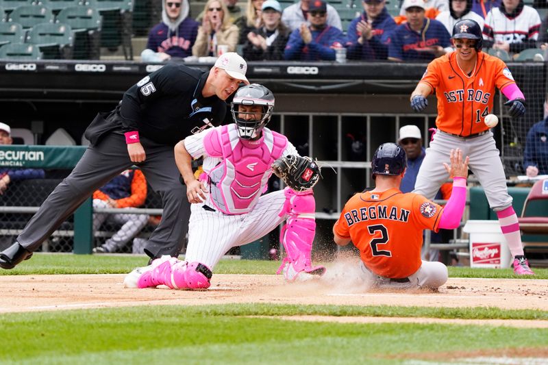 May 14, 2023; Chicago, Illinois, USA; Houston Astros third baseman Alex Bregman (2) is safe at home plate as Chicago White Sox catcher Seby Zavala (44) takes a late throw during the first inning at Guaranteed Rate Field. Mandatory Credit: David Banks-USA TODAY Sports