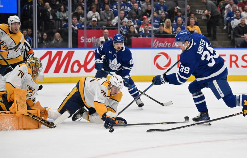 Dec 4, 2024; Toronto, Ontario, CAN;  Toronto Maple Leafs forward Fraser Minten (39) shoots the puck as Nashville Predators defenseman Brady Skjei (76) defends in front of goalie Jusse Saros (74) in the first period at Scotiabank Arena. Mandatory Credit: Dan Hamilton-Imagn Images