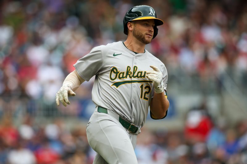 Jun 1, 2024; Atlanta, Georgia, USA; Oakland Athletics shortstop Max Schuemann (12) runs to first on a RBI single against the Atlanta Braves in the second inning at Truist Park. Mandatory Credit: Brett Davis-USA TODAY Sports