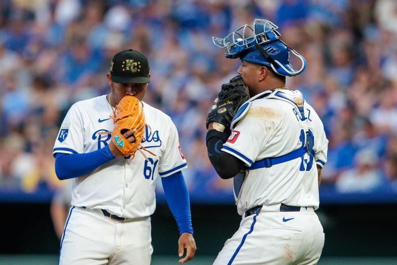 May 18, 2024; Kansas City, Missouri, USA; Kansas City Royals catcher Salvador Perez (13) speaks to Kansas City Royals pitcher Angel Zerpa (61) during the eighth inning against the Oakland Athletics at Kauffman Stadium. Mandatory Credit: William Purnell-USA TODAY Sports