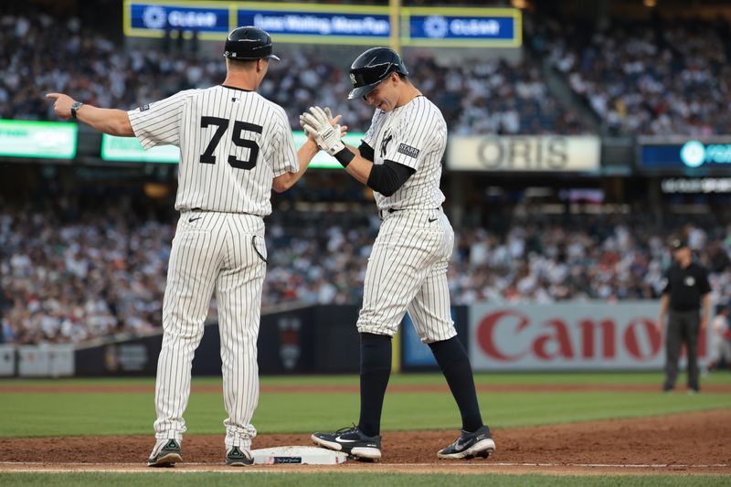 Jun 18, 2024; Bronx, New York, USA; New York Yankees first baseman Ben Rice (93) celebrates with first base coach Travis Chapman (75) after hitting a single during the third inning against the Baltimore Orioles at Yankee Stadium. Mandatory Credit: Vincent Carchietta-USA TODAY Sports