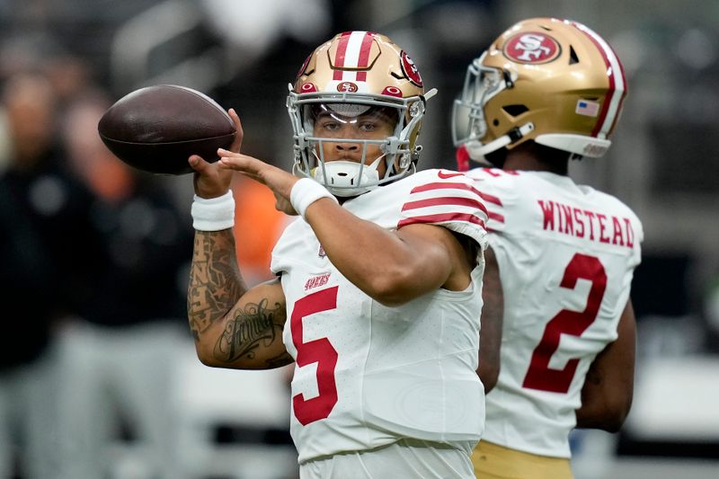 San Francisco 49ers quarterback Trey Lance (5) warms up prior to an NFL preseason football game against the Las Vegas Raiders, Sunday, Aug. 13, 2023, in Las Vegas. (AP Photo/John Locher)