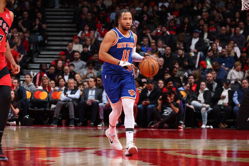 TORONTO, CANADA - MARCH 27: Jalen Brunson #11 of the New York Knicks dribbles the ball during the game against the Toronto Raptors on March 27, 2024 at the Scotiabank Arena in Toronto, Ontario, Canada.  NOTE TO USER: User expressly acknowledges and agrees that, by downloading and or using this Photograph, user is consenting to the terms and conditions of the Getty Images License Agreement.  Mandatory Copyright Notice: Copyright 2024 NBAE (Photo by Vaughn Ridley/NBAE via Getty Images)